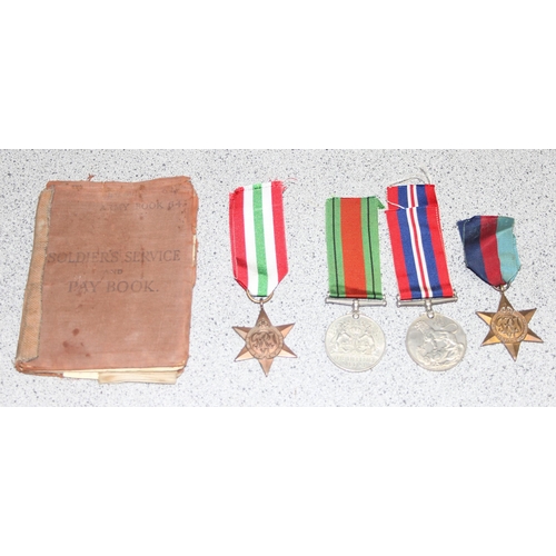 1469 - A WW2 military medals to inc an Italy Star and a WW2 period Soldiers pay book and paperwork