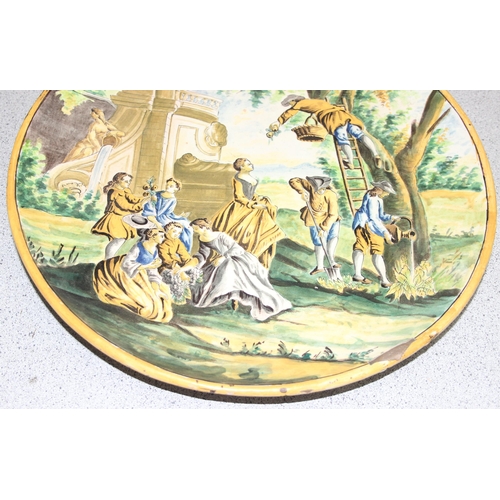 1699T - A large Italian Maiolica style charger decorated with a classical scene of fruit picking - likely 19... 