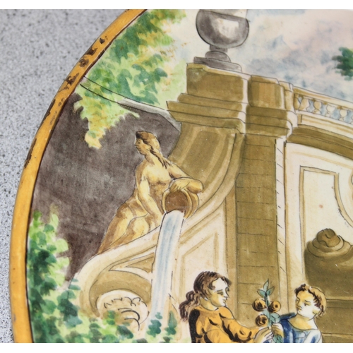 1699T - A large Italian Maiolica style charger decorated with a classical scene of fruit picking - likely 19... 