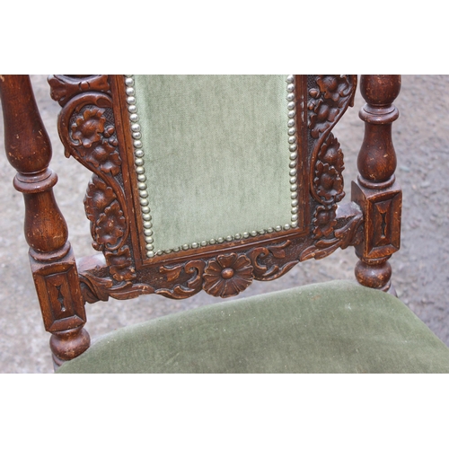 197 - A 17th century style carved oak hall chair with upholstered seat, likely late 19th or early 20th cen... 