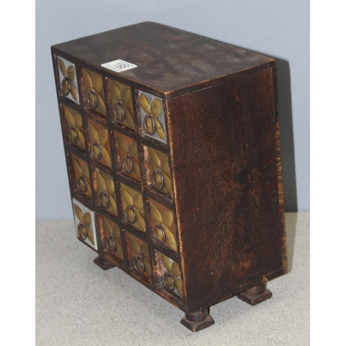 198 - A small rustic table top collectors chest of drawers, 16 drawers with metal mountings, approx 25cm w... 