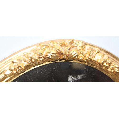 483 - An antique style oval gilt framed mirror, approx 58cm x 47cm