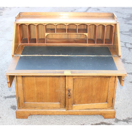 25 - An early 20th century light oak bureau, approx 107cm wide x 50cm deep x 104cm tall