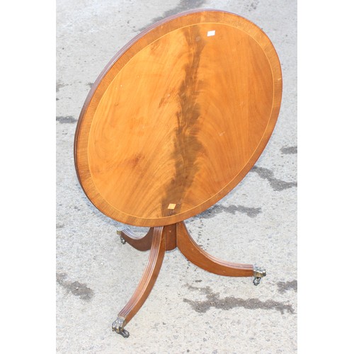 56 - A small antique style mahogany tilt top table, approx 63cm wide x 53cm tall