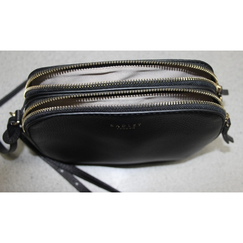 214 - A vintage Radley black leather handbag with dust bag and strap, approx 24cm wide