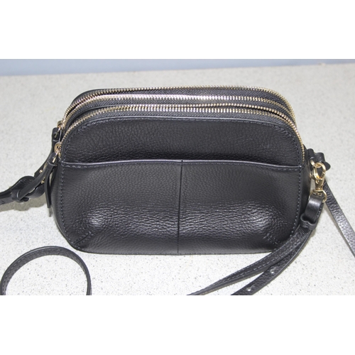 214 - A vintage Radley black leather handbag with dust bag and strap, approx 24cm wide