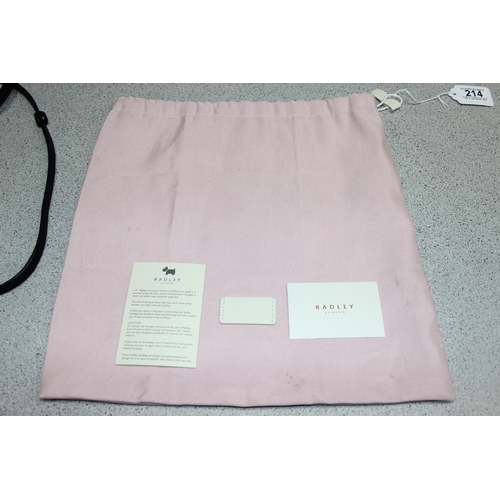 214 - A vintage Radley black leather handbag with dust bag and strap, approx 24cm wide