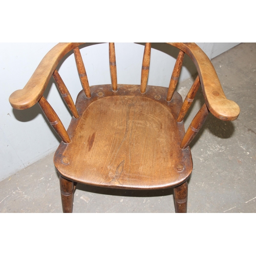 26 - A pair of vintage Oak smoker's bow or captain's armchairs, dated 1934/1935 to seat, made by O Haines... 