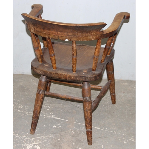 26 - A pair of vintage Oak smoker's bow or captain's armchairs, dated 1934/1935 to seat, made by O Haines... 