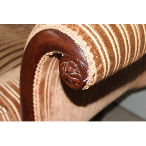 28 - A Regency period mahogany scroll arm sofa, circa 1820, the undulating back, arms, squab and bolster ... 