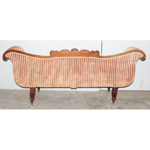 28 - A Regency period mahogany scroll arm sofa, circa 1820, the undulating back, arms, squab and bolster ... 