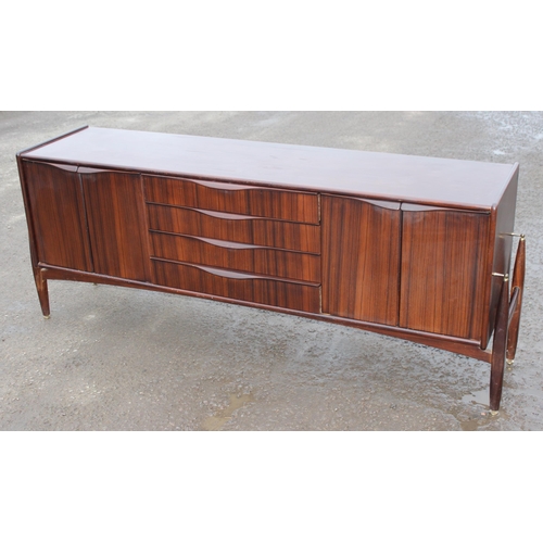 10 - An Elliotts of Newbury mid-century zebrano teak rosewood effect 'floating' sideboard, with four cent... 