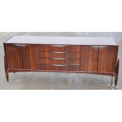 10 - An Elliotts of Newbury mid-century zebrano teak rosewood effect 'floating' sideboard, with four cent... 