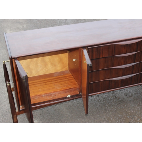 10 - An Elliotts of Newbury mid-century zebrano teak rosewood effect 'floating' sideboard, with four cent... 