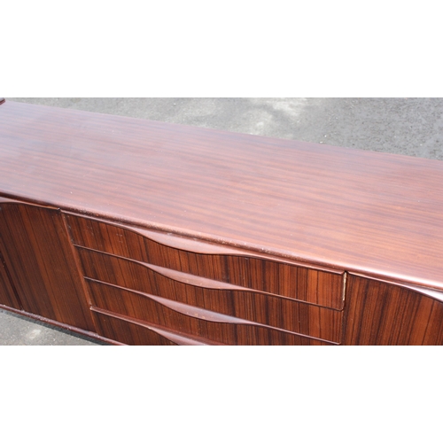 10 - An Elliotts of Newbury mid-century zebrano teak rosewood effect 'floating' sideboard, with four cent... 