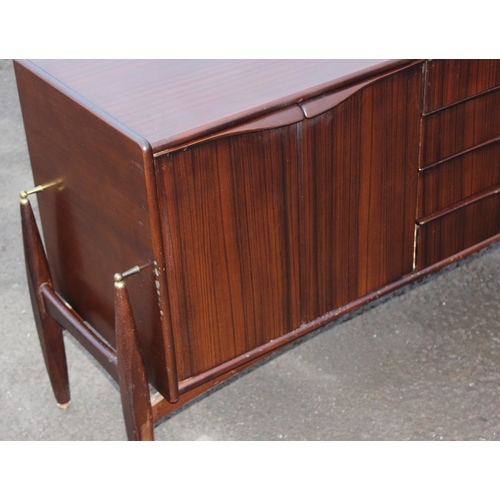 10 - An Elliotts of Newbury mid-century zebrano teak rosewood effect 'floating' sideboard, with four cent... 