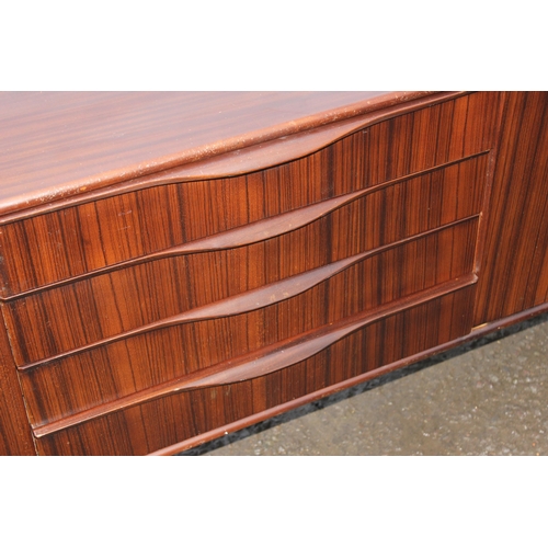 10 - An Elliotts of Newbury mid-century zebrano teak rosewood effect 'floating' sideboard, with four cent... 