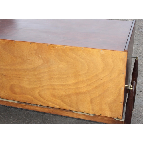 10 - An Elliotts of Newbury mid-century zebrano teak rosewood effect 'floating' sideboard, with four cent... 