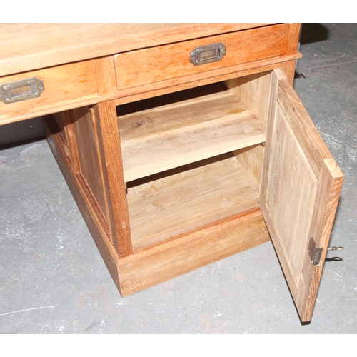 34 - A vintage pedestal desk with brass campaign style handles, 6 drawers and a cupboard, approx 176cm wi... 