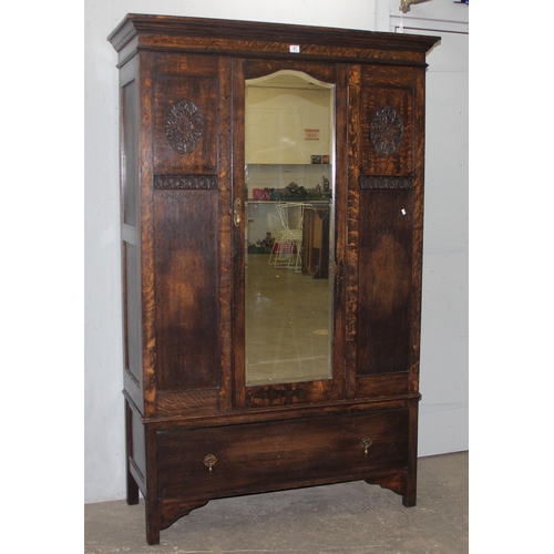 41 - An early 20th century oak wardrobe with mirrored door and carved details, approx 128cm wide x 53cm d... 