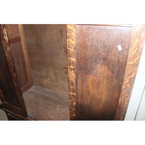 41 - An early 20th century oak wardrobe with mirrored door and carved details, approx 128cm wide x 53cm d... 