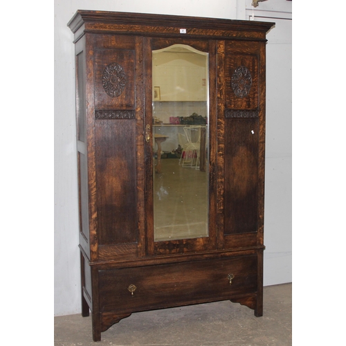 41 - An early 20th century oak wardrobe with mirrored door and carved details, approx 128cm wide x 53cm d... 