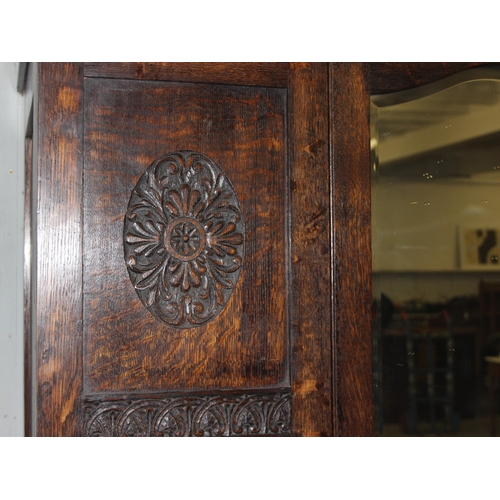 41 - An early 20th century oak wardrobe with mirrored door and carved details, approx 128cm wide x 53cm d... 