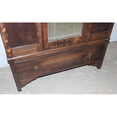 41 - An early 20th century oak wardrobe with mirrored door and carved details, approx 128cm wide x 53cm d... 