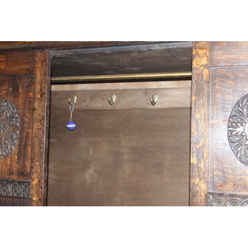 41 - An early 20th century oak wardrobe with mirrored door and carved details, approx 128cm wide x 53cm d... 