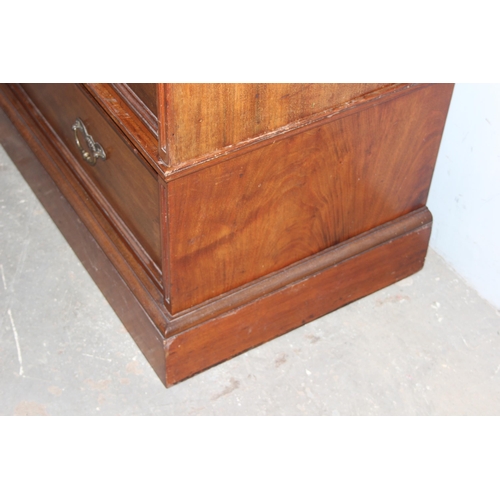 42 - An early 20th century mahogany gentleman's wardrobe with carved details and mirrored drawer, the rig... 