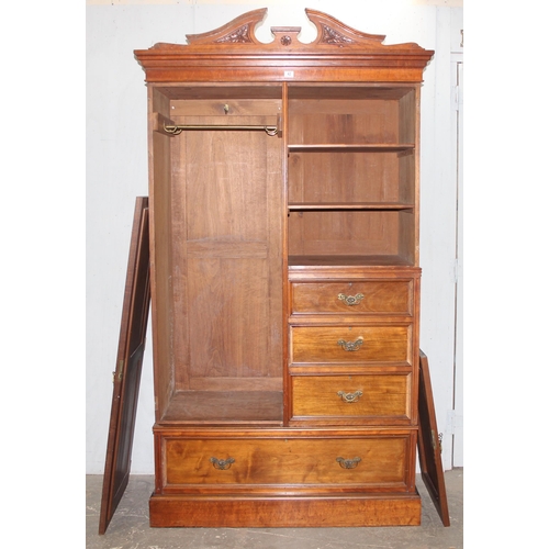 42 - An early 20th century mahogany gentleman's wardrobe with carved details and mirrored drawer, the rig... 