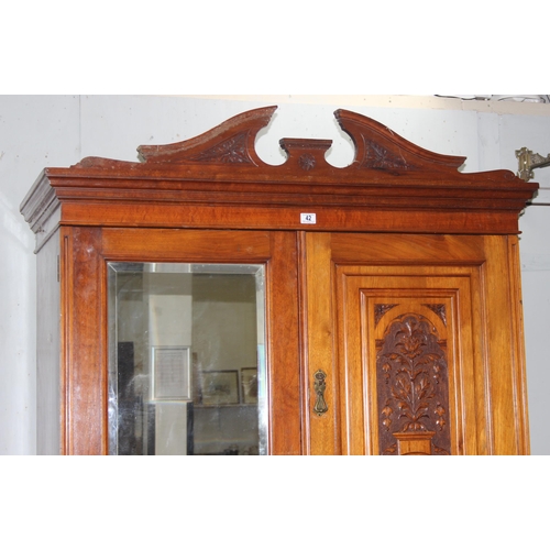 42 - An early 20th century mahogany gentleman's wardrobe with carved details and mirrored drawer, the rig... 