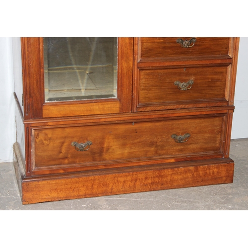 42 - An early 20th century mahogany gentleman's wardrobe with carved details and mirrored drawer, the rig... 