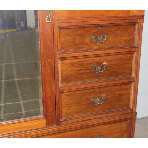 42 - An early 20th century mahogany gentleman's wardrobe with carved details and mirrored drawer, the rig... 