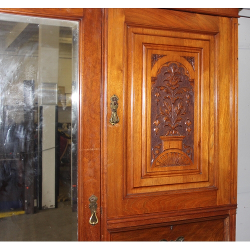 42 - An early 20th century mahogany gentleman's wardrobe with carved details and mirrored drawer, the rig... 