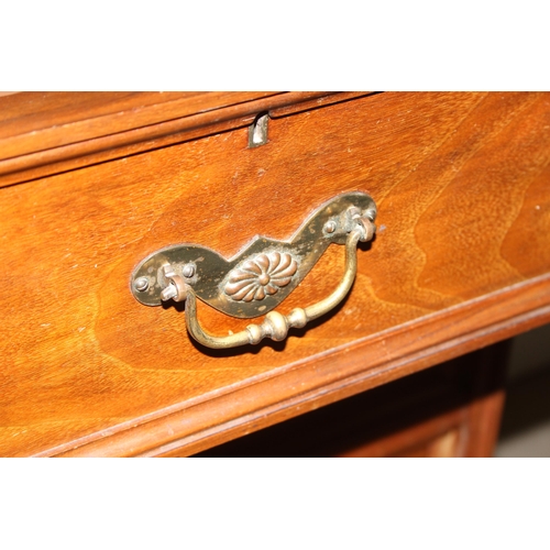 42 - An early 20th century mahogany gentleman's wardrobe with carved details and mirrored drawer, the rig... 