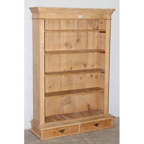 4 - A vintage pine bookcase with 2 short drawers to base, approx 110cm wide x 38cm deep x 162cm tall