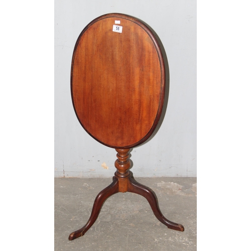 58 - An antique mahogany tilt topped side table with oval top and tripod base, approx 42cm wide x 52cm de... 