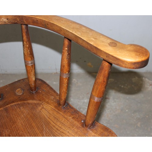 26 - A pair of vintage Oak smoker's bow or captain's armchairs, dated 1934/1935 to seat, made by O Haines... 