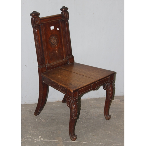 47 - A 19th century carved oak hall chair