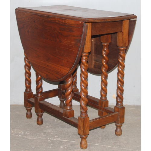 115 - An early 20th century oak drop leaf table with barley twist legs, approx 118cm W x 74cm D x 78cm H w... 