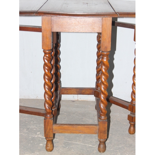 115 - An early 20th century oak drop leaf table with barley twist legs, approx 118cm W x 74cm D x 78cm H w... 