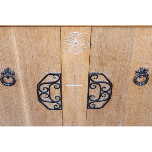 124 - An unusual carved light oak sideboard or buffet stand with 3 drawers above 2 cupboards, the piece wi... 