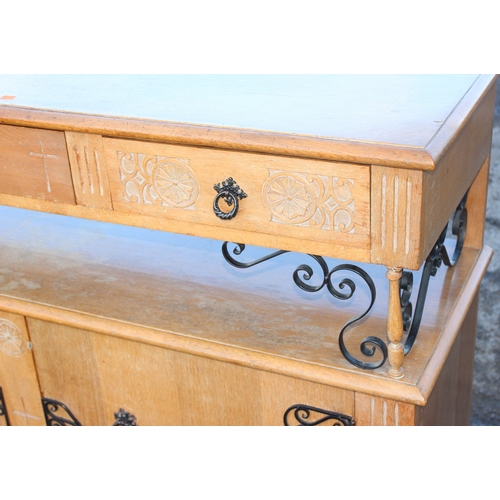 124 - An unusual carved light oak sideboard or buffet stand with 3 drawers above 2 cupboards, the piece wi... 