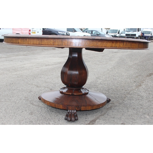 133 - A Victorian rosewood breakfast table with tilt top and impressive pedestal base with paw feet, appro... 