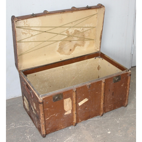 142 - A large vintage flat topped steamer trunk with canvas covering and wooden struts, approx 92cm wide x... 