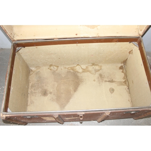 142 - A large vintage flat topped steamer trunk with canvas covering and wooden struts, approx 92cm wide x... 
