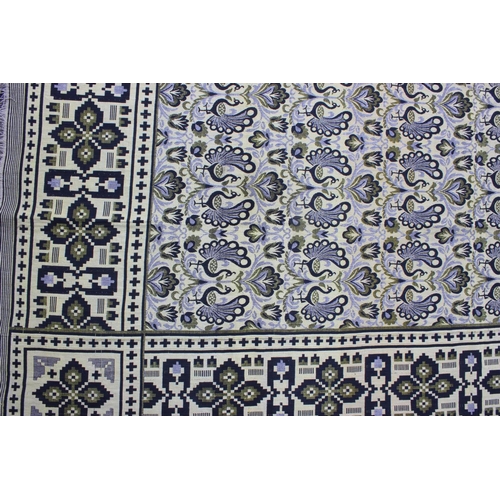 218 - A large reversible fabric blanket or throw decorated with peacocks, approx 218cm wide x 220cm deep