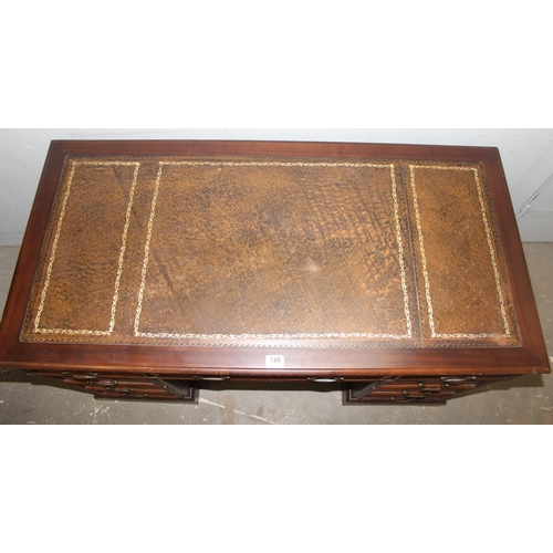 146 - A vintage leather topped pedestal desk with 9 drawers and brass handles, approx 123cm wide x 61cm de... 