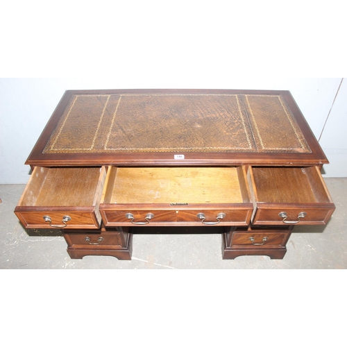 146 - A vintage leather topped pedestal desk with 9 drawers and brass handles, approx 123cm wide x 61cm de... 